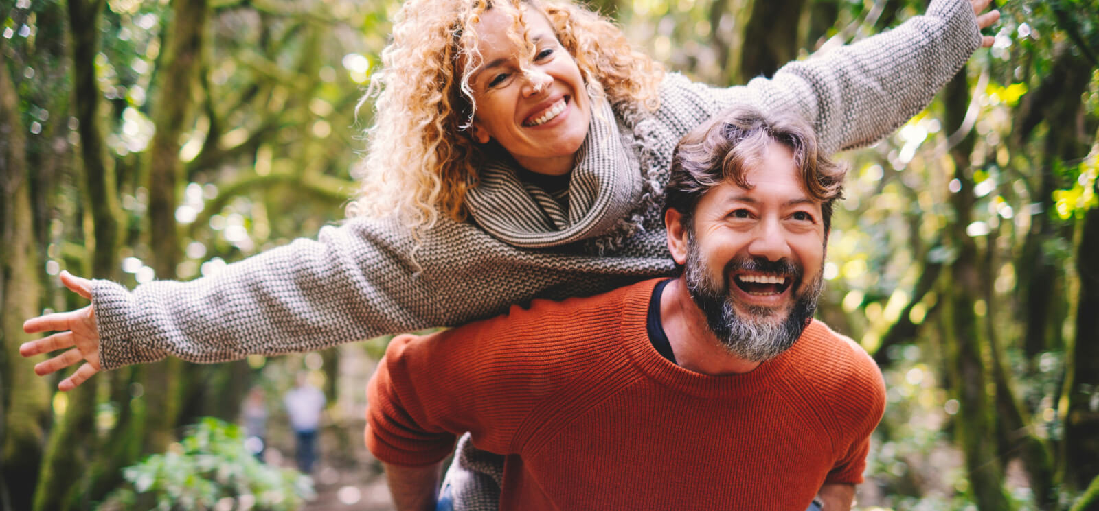 Man giving woman a piggy back ride 